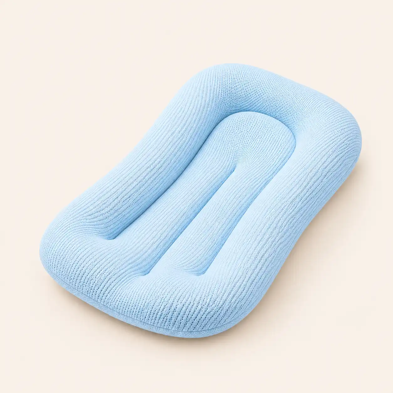 Soft light blue knit baby lounger nest with supportive contoured design, placed on a neutral background for newborn lounging and co-sleeping.